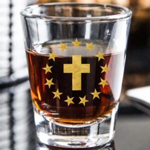 Whiskey shot glass with cross and stars.