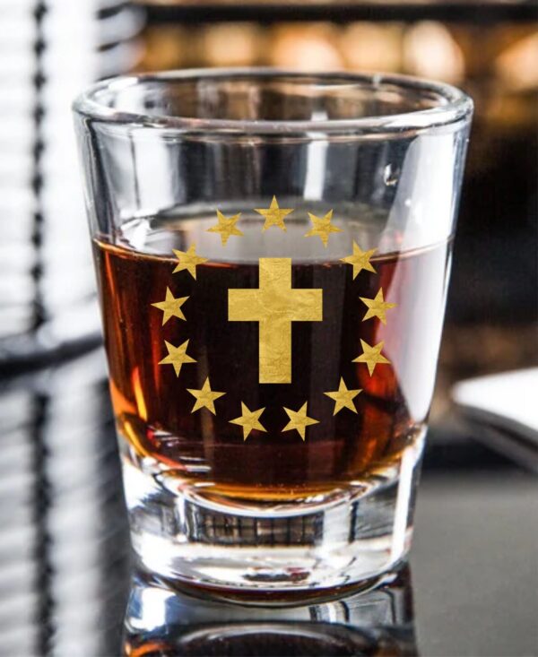 Whiskey shot glass with cross and stars.
